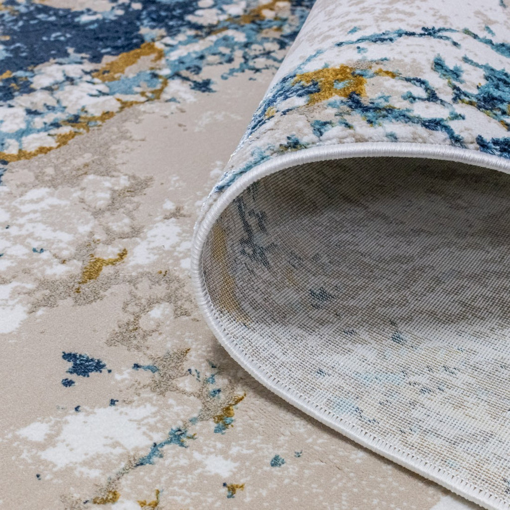 Paradise Living – Tapete Batik 38/004 Azul, detalhe da base antiderrapante e acabamento do rebordo, padrão abstrato azul e dourado