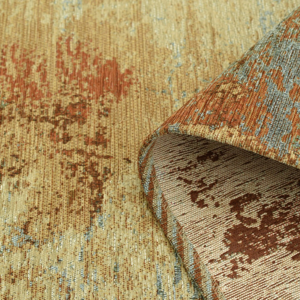 Paradise Living – Tapete Ametist Chenille 287 Multicolor close-up do canto enrolado mostrando textura chenille em tons bege, terracota e azul e verso em tecido creme